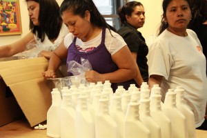 The women from the Si Se Puede Coop bottling their new cleaner.